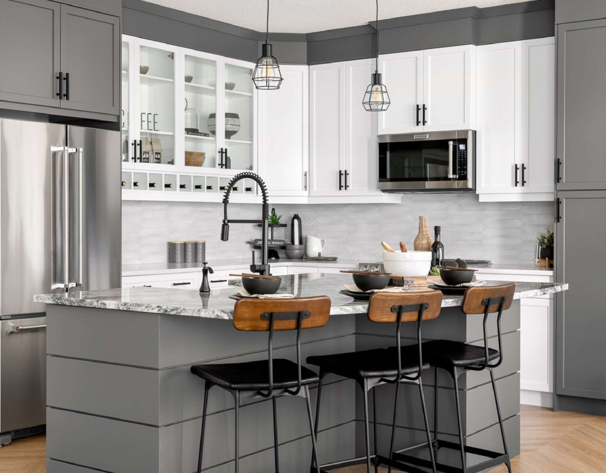 L-Shaped Kitchen with kitchen island, refrigerator, pendant light, white cabinets, wood flooring