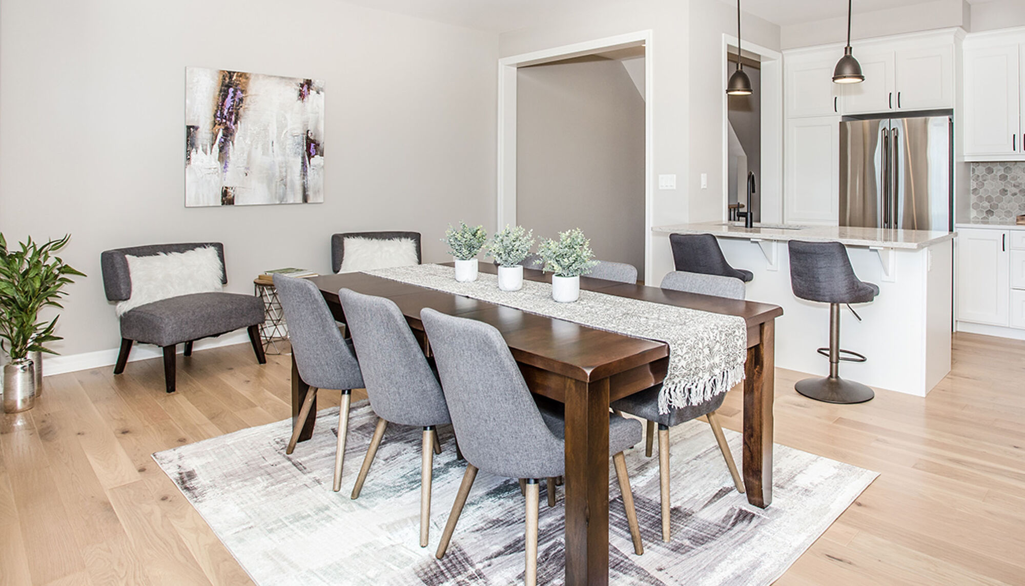 Dining Room with a rectangular wooden table surrounded by grey chairs.