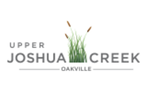 Upper Joshua Creek logo with blades of grass between text Joshua and Creek. 
