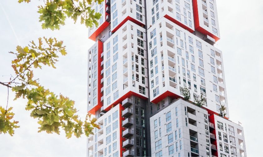 Picasso, a white and grey modular-looking high rise building in downtown Toronto with red accents.