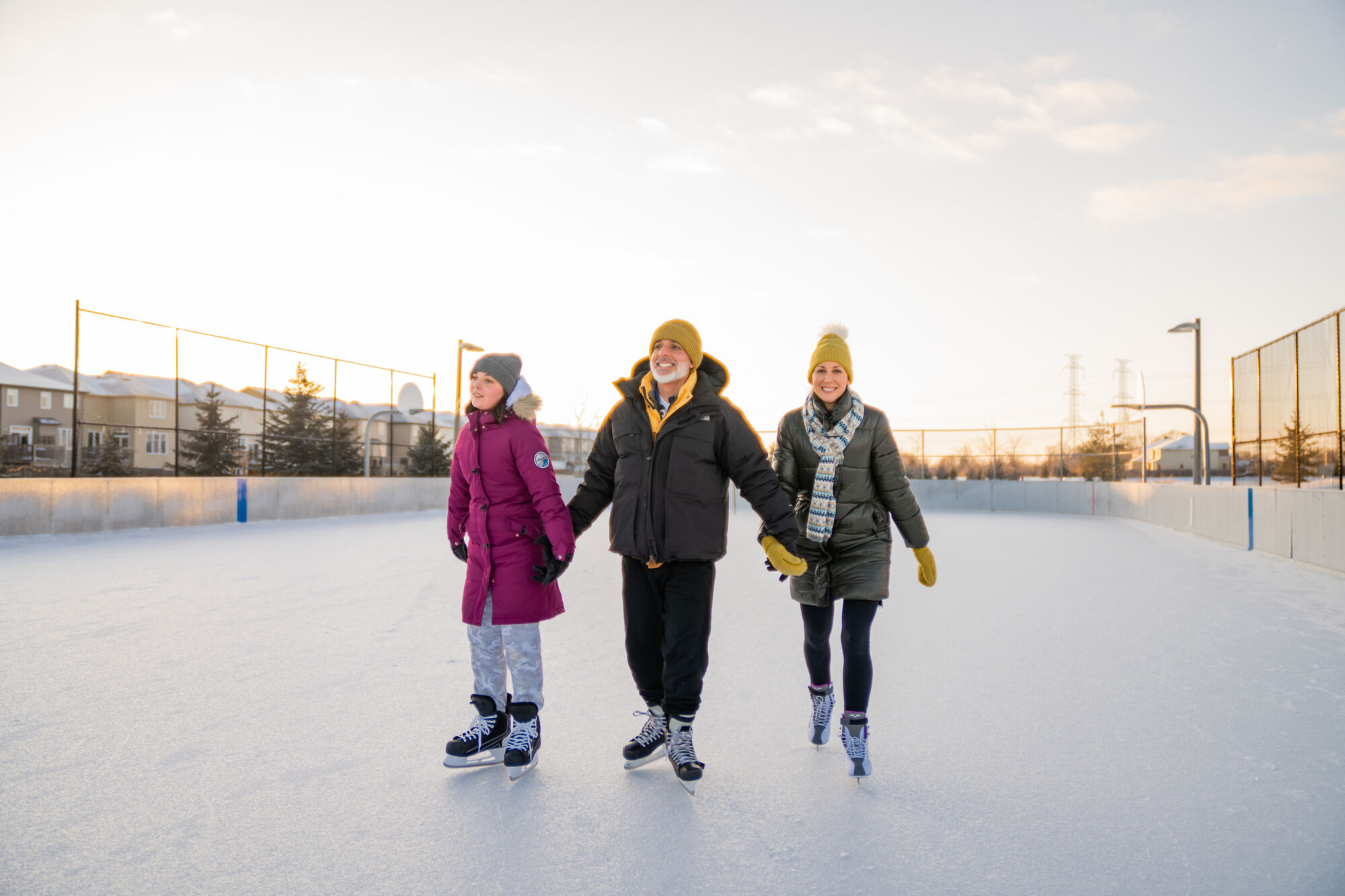 A family skating on an outdoor ice rink