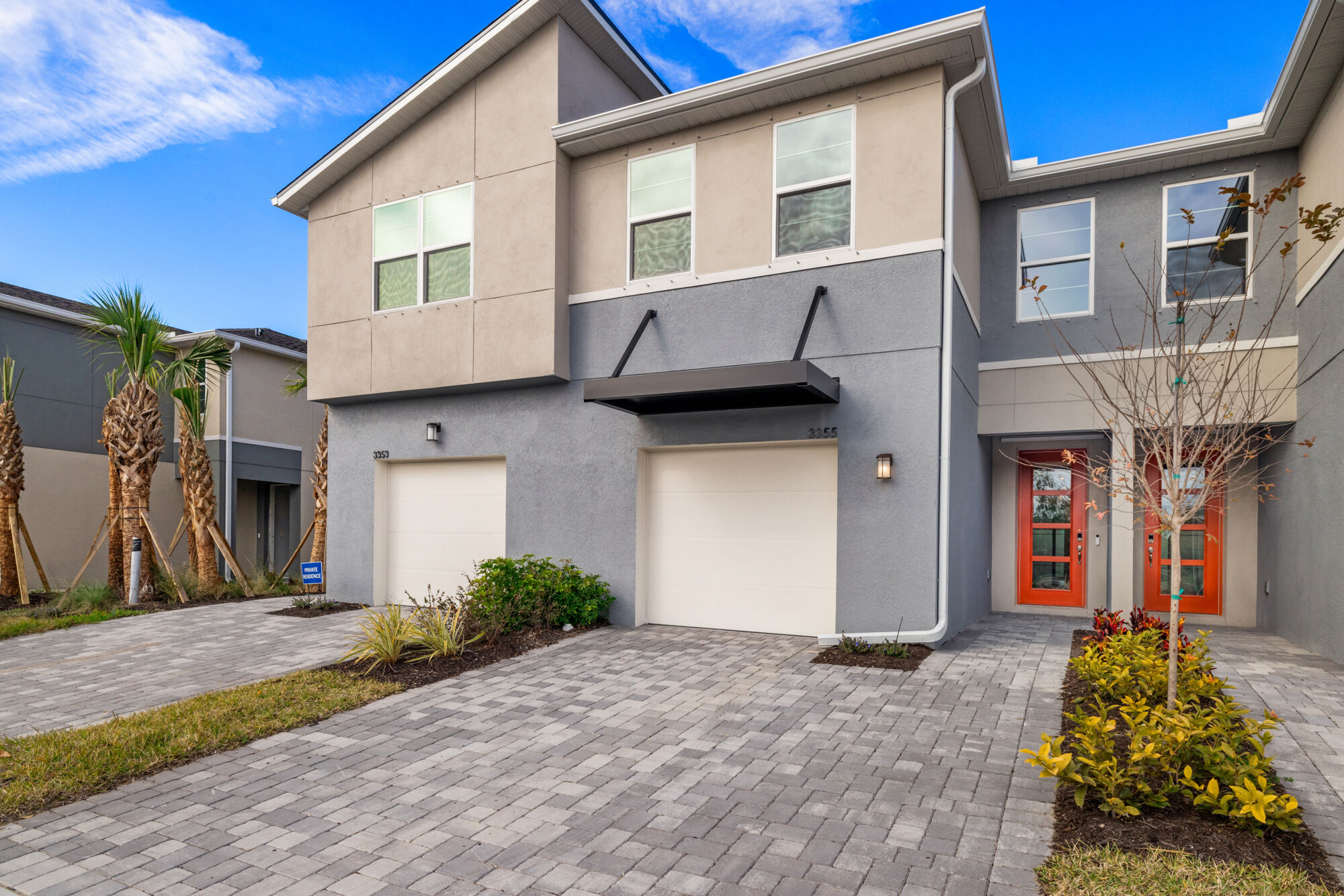 Townhome, 3 bedroom, 2 full baths, powder room, loft, screened lanai, contemporary exterior, light gray cabinets, contrasting Frost White quartz countertops, plank tile flooring on main level. laundry room, stainless steel appliances, refrigerator