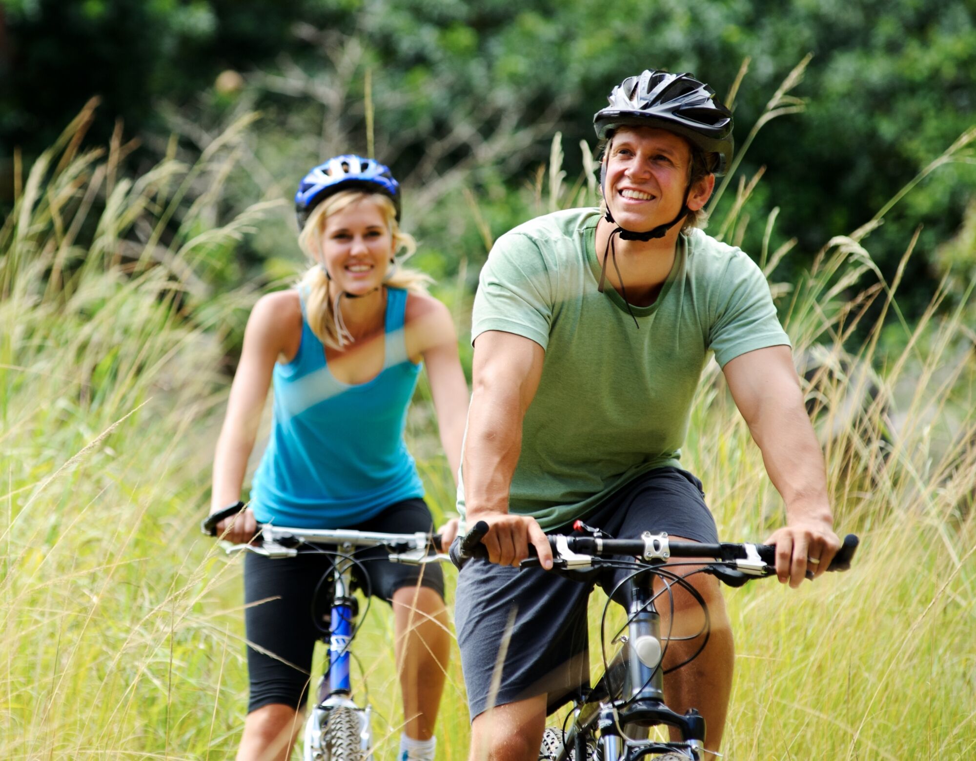 man and woman biking outdoors