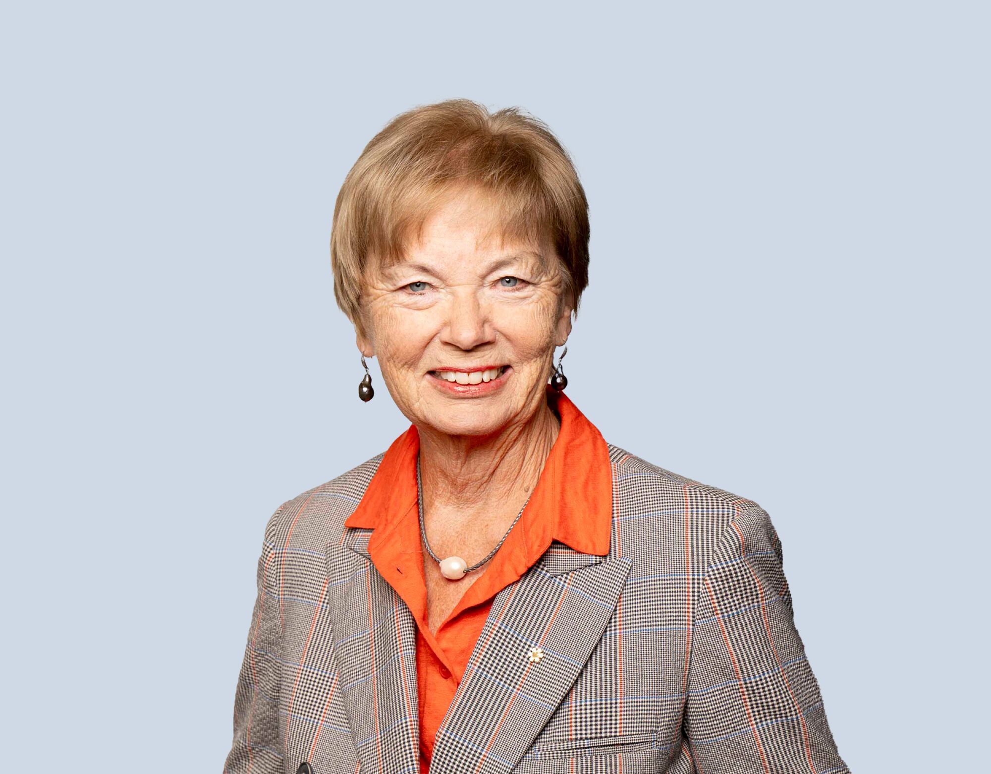 Carol Stephenson, member of Mattamy Asset Management's Board of Directors, wearing a plaid blazer and smiling in front of a light blue background