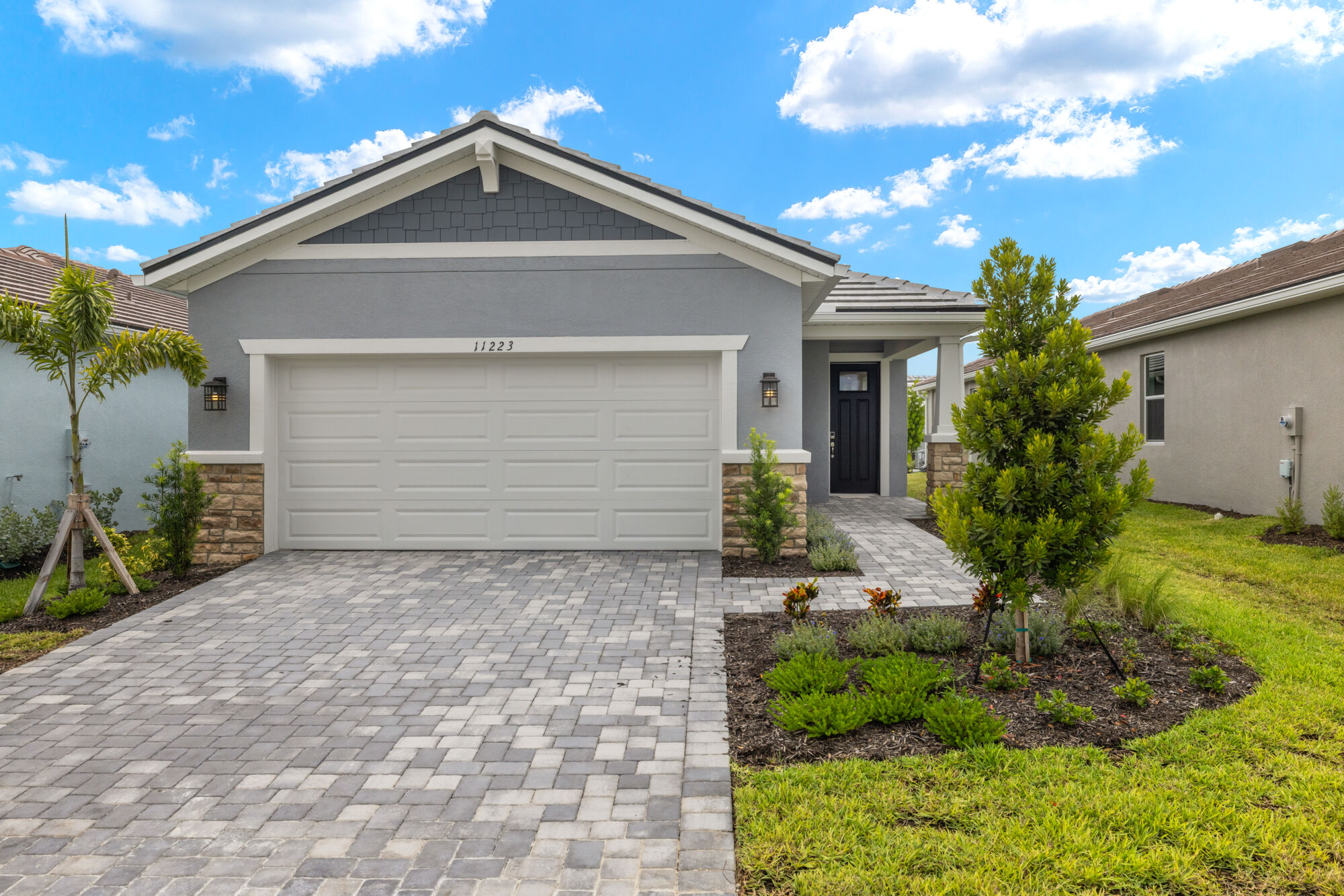 single family, single story 2 bedroom, 2 bath, open concept, quartz countertops, kitchen island with breakfast bar, walk-in closet in Owners en suite, extended shower, 2 car garage covered lanai