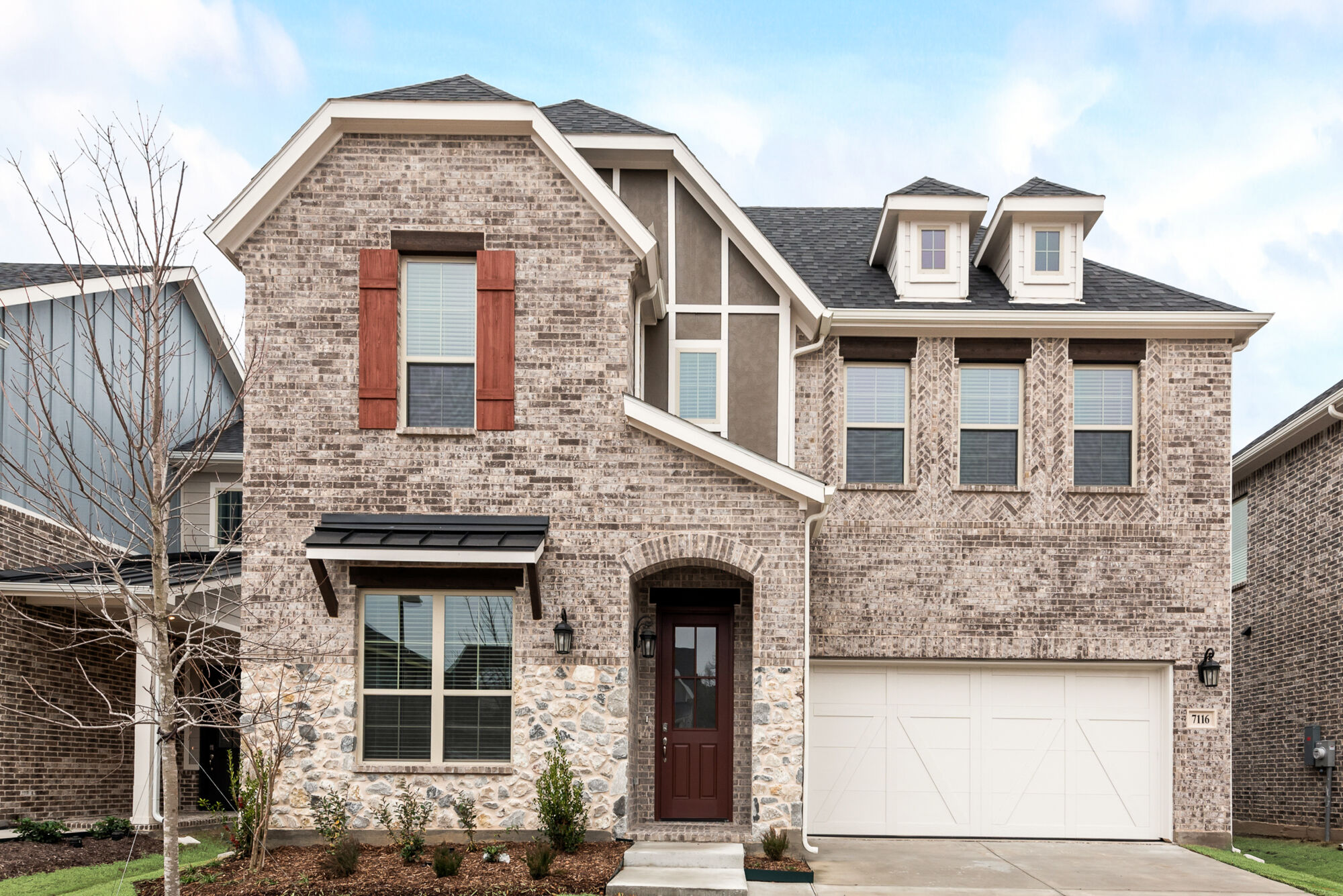 Elevation Front with window, garage, door, exterior brick and exterior stone