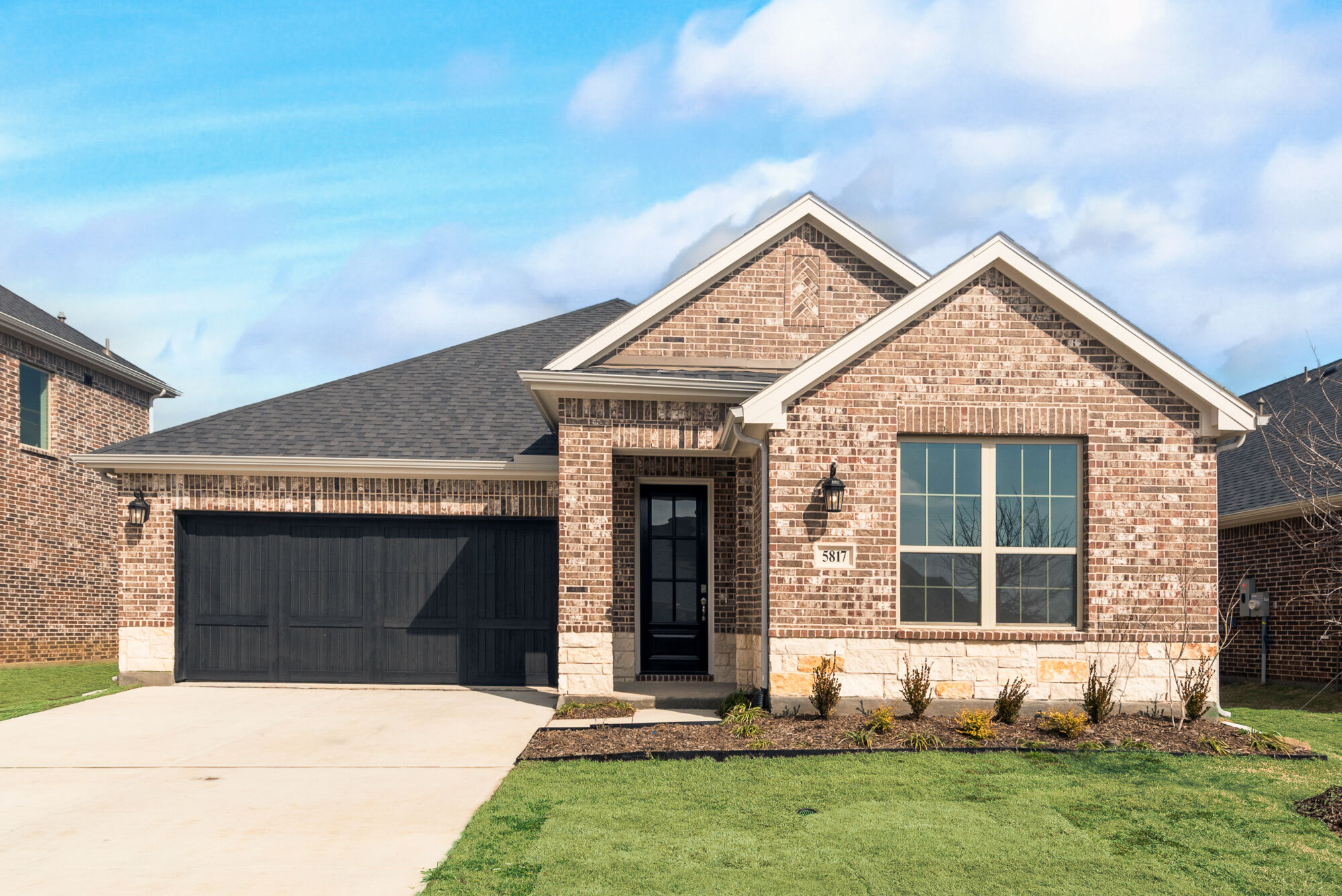 Elevation Front with window, garage, door and exterior brick