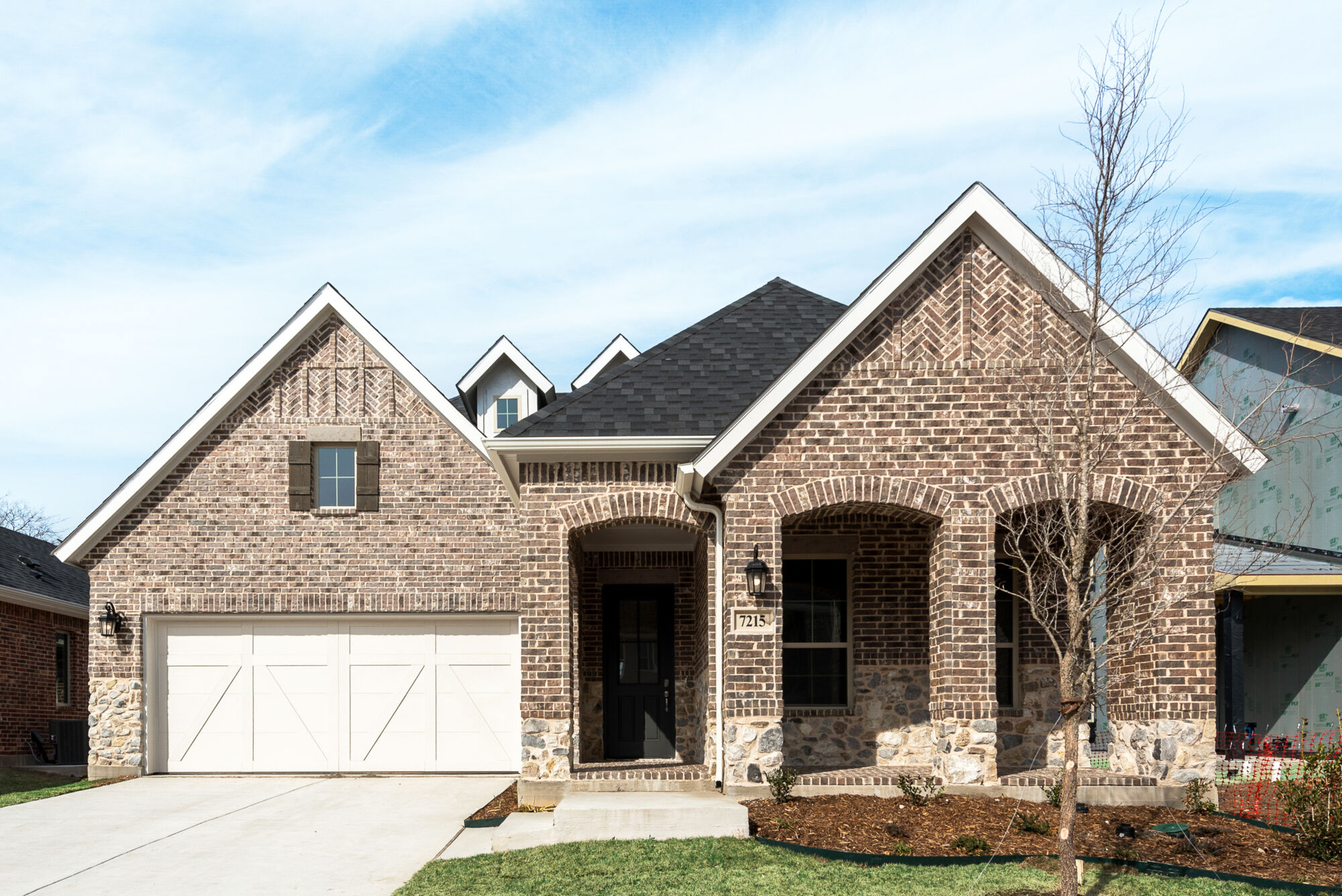 Elevation Front with garage, door, window and exterior brick