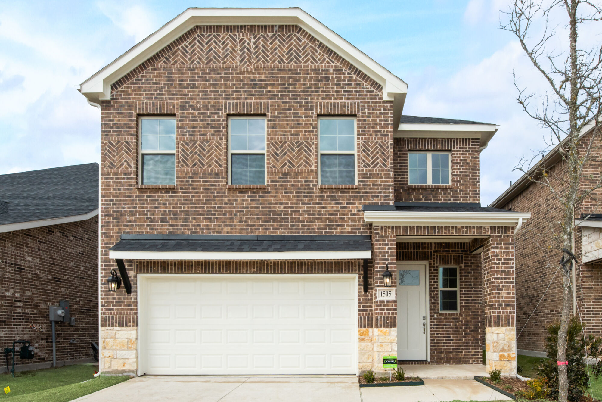 Elevation Front with window, garage, door, exterior brick and exterior stone